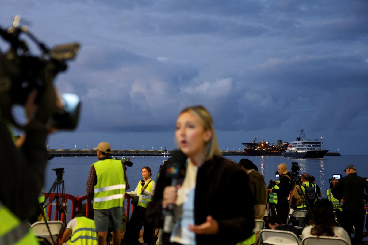 Members of the media work at the port of Granadilla de Abona following the arrival of the cruise ship MV Hondius after being affected by a hantavirus outbreak, in Tenerife, Spain, May 10, 2026. REUTERS/Hannah McKay