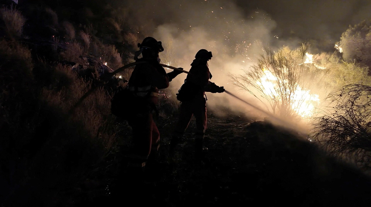 Firefighters work to control a wildfire in Almeria, Spain in this screen grab from handout video released July 11, 2026.     Spanish Military Emergency Unit/Handout via REUTERS