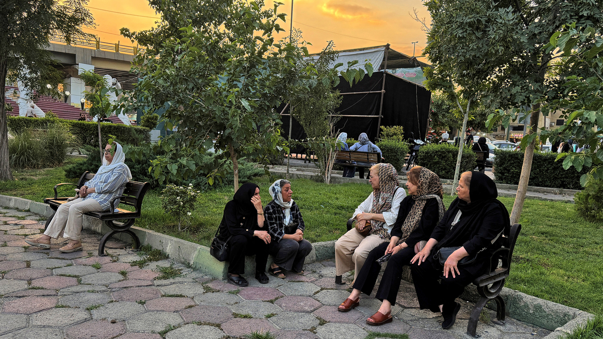 Iranians chat in a park in Tehran on June 22, 2026. The United States temporarily suspended sanctions on Iranian oil on June 22 after Vice President JD Vance said Iran would allow UN nuclear inspectors to return to the country, following talks in Switzerland.
