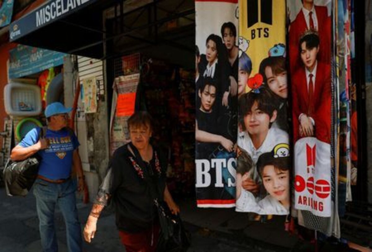 FILE PHOTO: People walk past blankets featuring South Korean Kpop boy band BTS displayed for sale in a shop ahead of concerts on the BTS world tour "Arirang", as the bond between Korea and Mexico, one of the world’s more unusual geo-cultural connections, continues to grow, with Korean influence gaining a foothold despite distance, language barriers and a 15-hour time difference, in Mexico City, Mexico, April 29, 2026. REUTERS/Henry Romero/File Photo