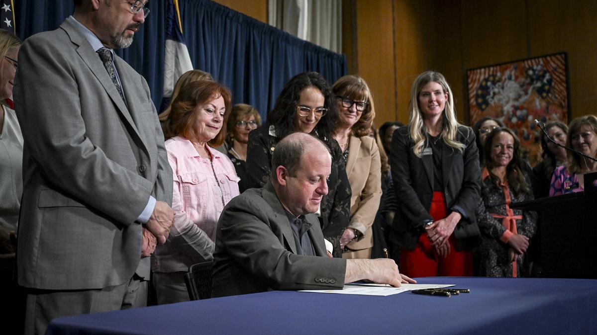 Gov. Jared Polis signs Senate Bill 183 into law at the Colorado State Capitol in Denver on Thursday, April 24, 2025. Joined by state lawmakers and advocates, he signed that bill, which allows public funding of abortion and implements a voter-passed constitutional amendment, and Senate Bill 129, which aims to give more protections to abortion providers and patients. (AAron Ontiveroz/The Denver Post/TNS)