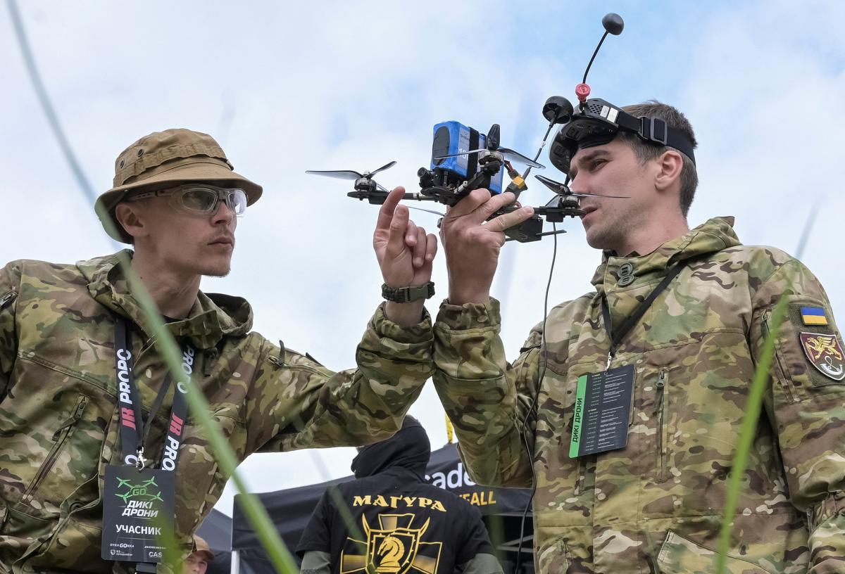 Participants of the Wild Drones competition check a first-person view (FPV) drone before a race, amid Russia's attack on Ukraine, in the town of Truskavets, Lviv region, Ukraine May 19, 2026. REUTERS/Stringer