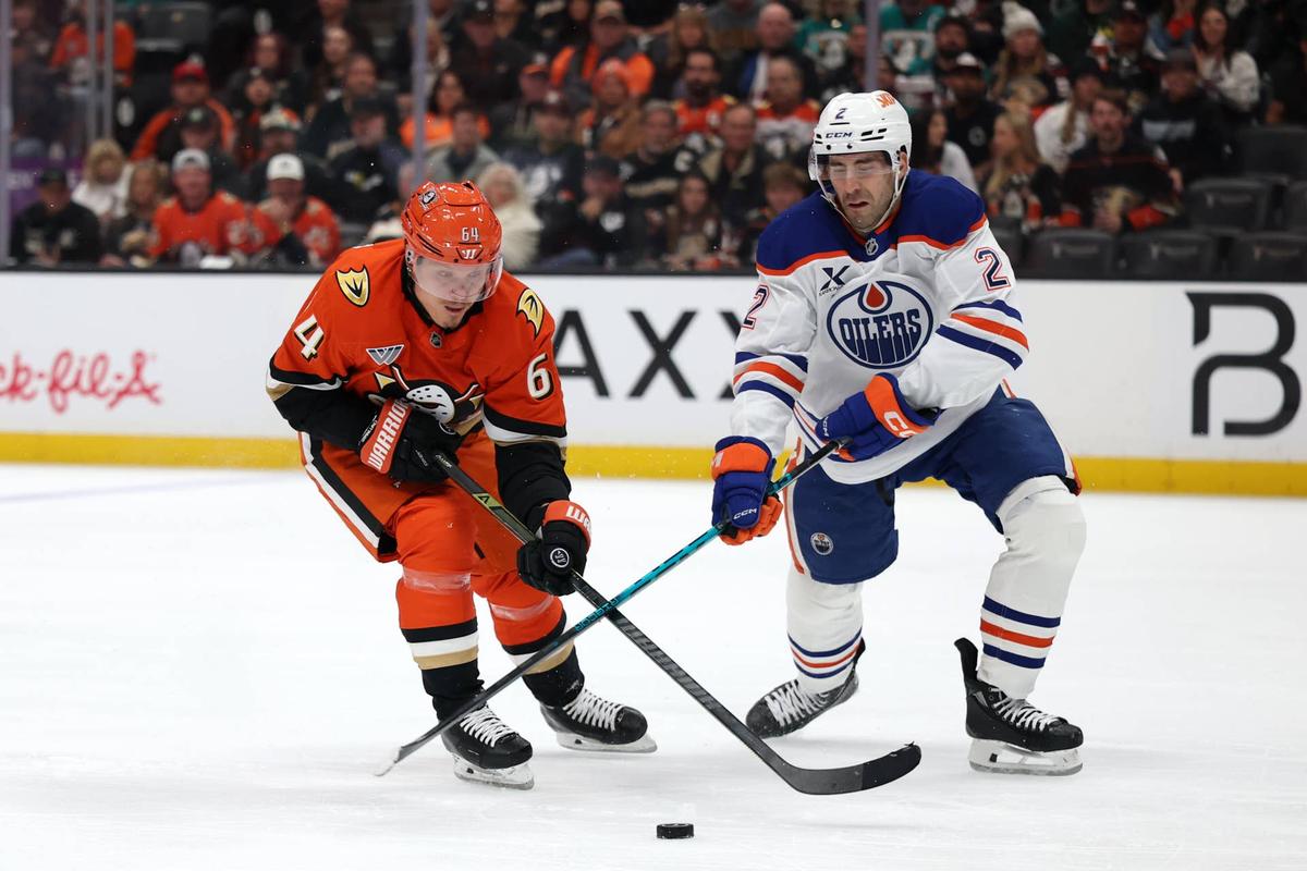  Anaheim Ducks center Mikael Granlund (64) fights for the puck against Edmonton Oilers defenseman Evan Bouchard (2) during the 2026 Stanley Cup Playoffs. Kiyoshi Mio-Imagn Images
