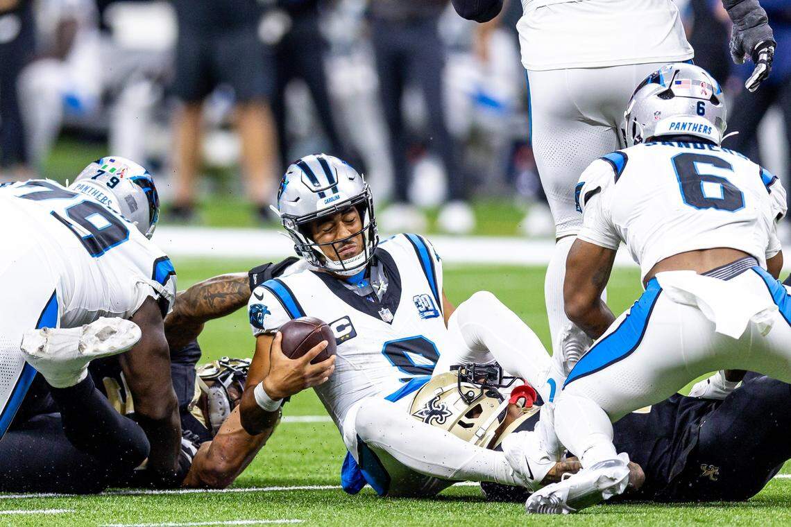 Carolina Panthers quarterback Bryce Young (9) is tackled as he scrambles out the pocket by New Orleans Saints cornerback Alontae Taylor during the second half at Caesars Superdome.