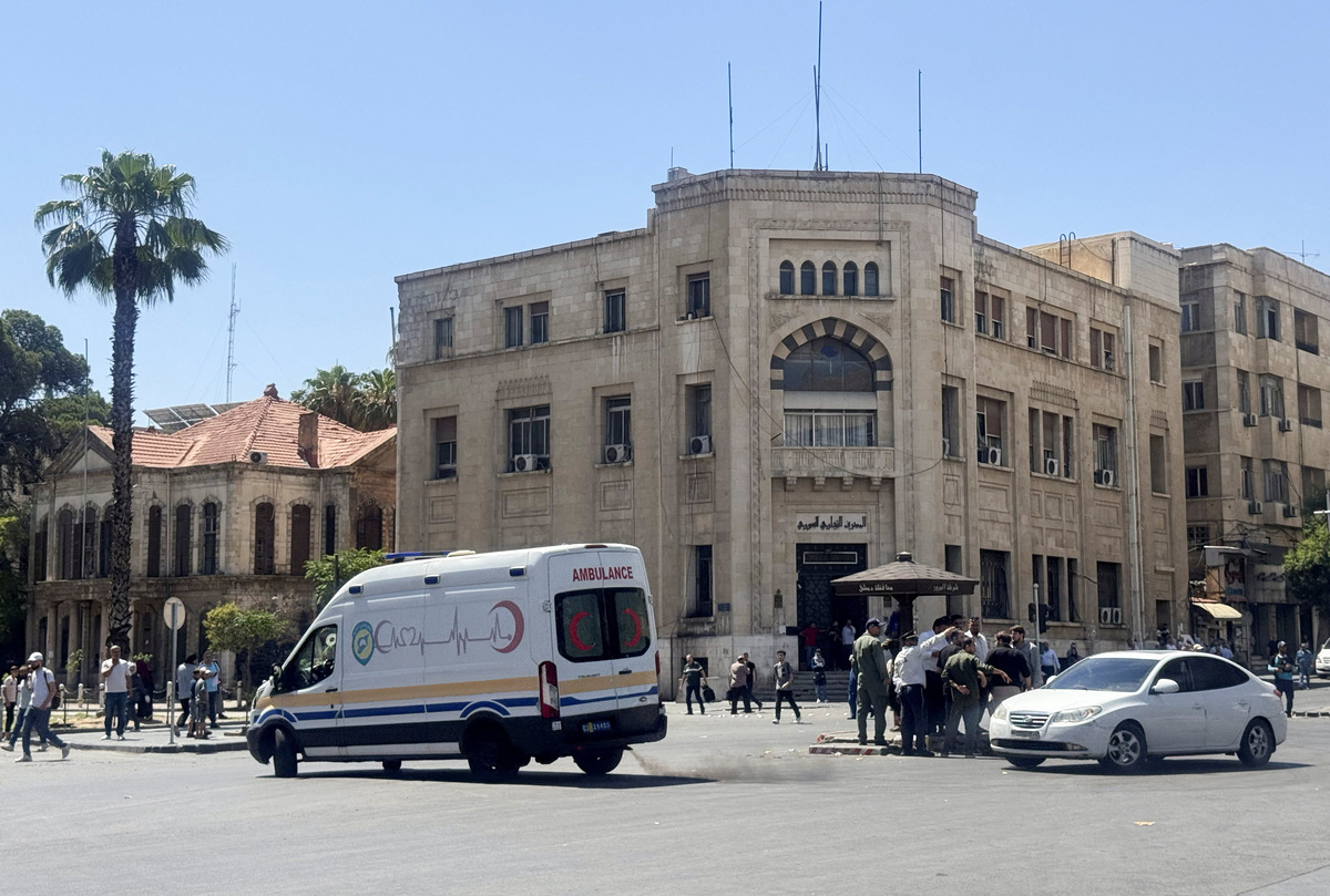 An ambulance drives past the site where explosive devices blew up near a hotel where French President Emmanuel Macron was meant to be staying, in Damascus, Syria, July 7, 2026. Picture taken with a mobile phone. REUTERS/Yamam Al Shaar