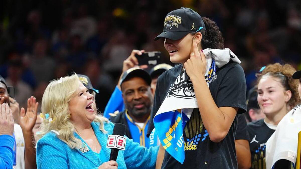  Apr 5, 2026; Phoenix, AZ, USA; ESPN reporter Holly Rowe speaks to UCLA Bruins center Lauren Betts (51) on the podium after the win against the South Carolina Gamecocks in the National Championship game of the women's 2026 NCAA Tournament at Mortgage Matchup Center. Mandatory Credit: Kirby Lee-Imagn Images | Kirby Lee-Imagn Images 