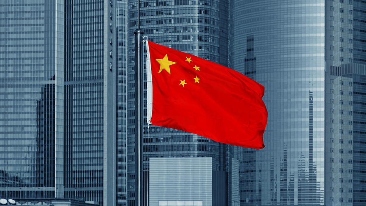 La bandera de China ondea con rascacielos de fondo