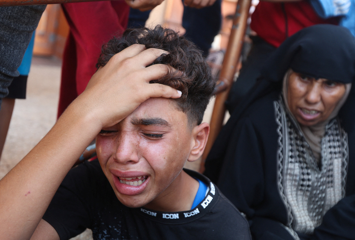 A child reacts during the funeral of Palestinian child Muataz Abu Shaar,  who was killed by Israeli fire, according to medics, in Khan Younis, in the southern Gaza Strip, July 14, 2026. REUTERS/Ramadan Abed