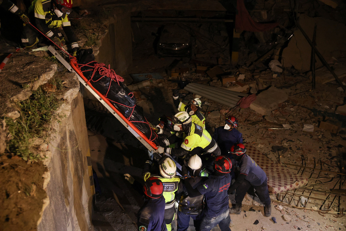 Members of Ecuadorian ECU-11 Guayaquil Fire Department and Portuguese firefighters recover the body of a casualty from a building that collapsed from the ground floor to the fifth floor, following major earthquakes, in La Guaira, Venezuela, June 29, 2026. REUTERS/Leonardo Fernandez Viloria
