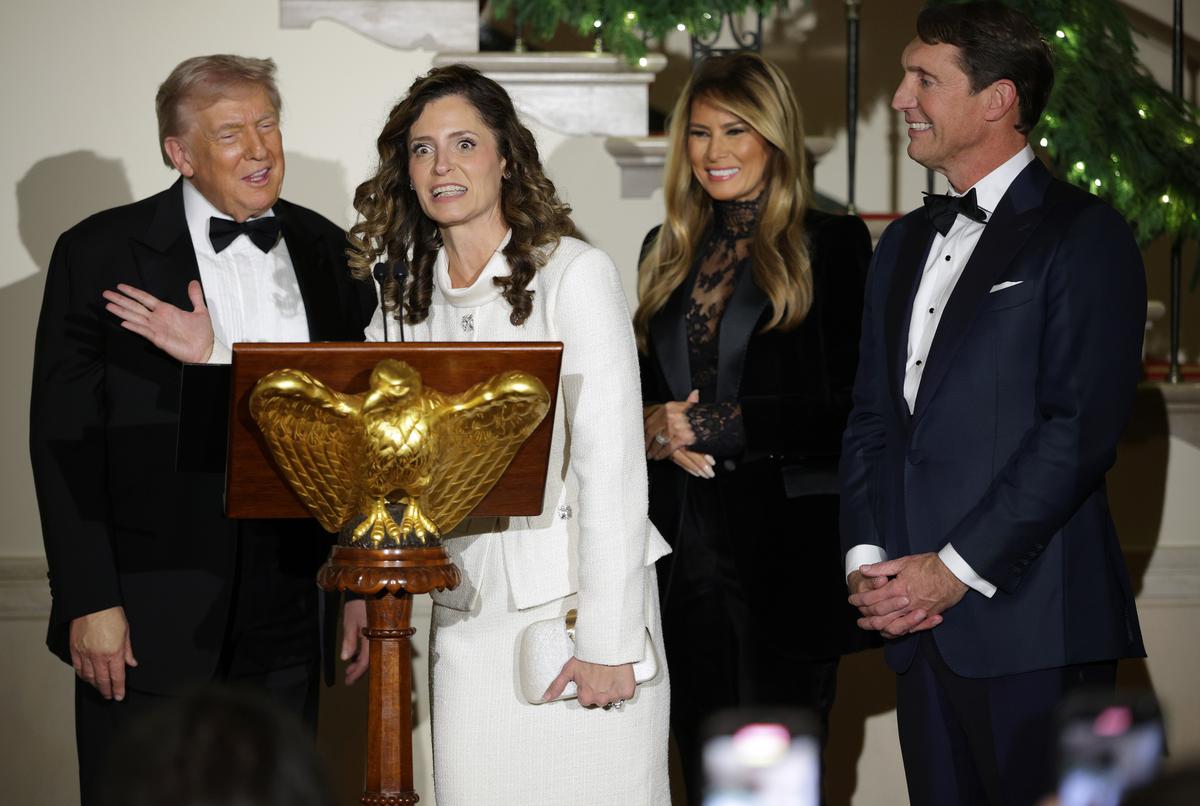  Representative Julia Letlow speaks alongside President Donald Trump (L) and first lady Melania Trump (2nd R) at the White House on December 11, 2025. 