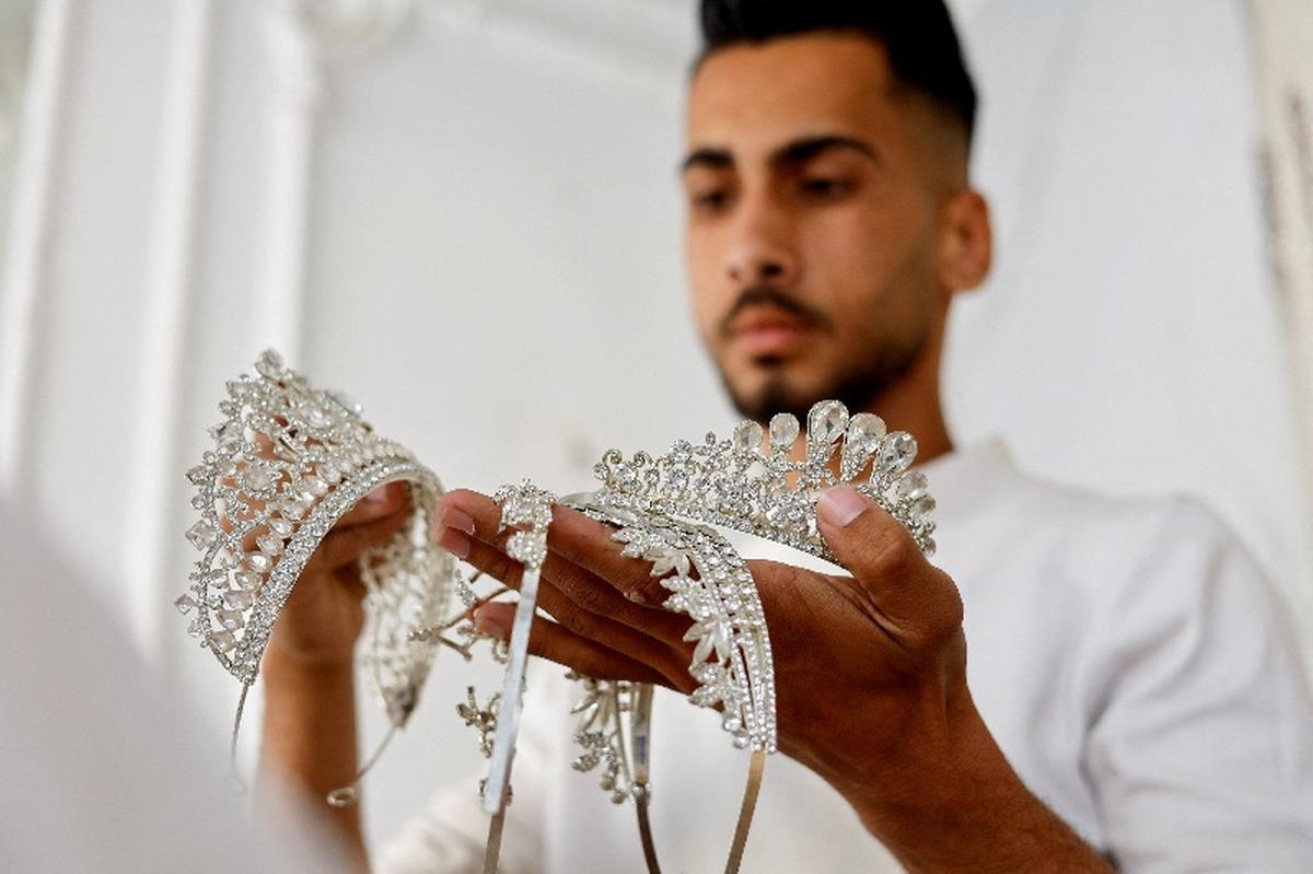 A Palestinian man displays accessories at a shop, as brides in Gaza turn to reused gowns amid soaring prices and shortages caused by the war, in Khan Younis in the southern Gaza Strip, May 9, 2026. REUTERS/Mahmoud Issa