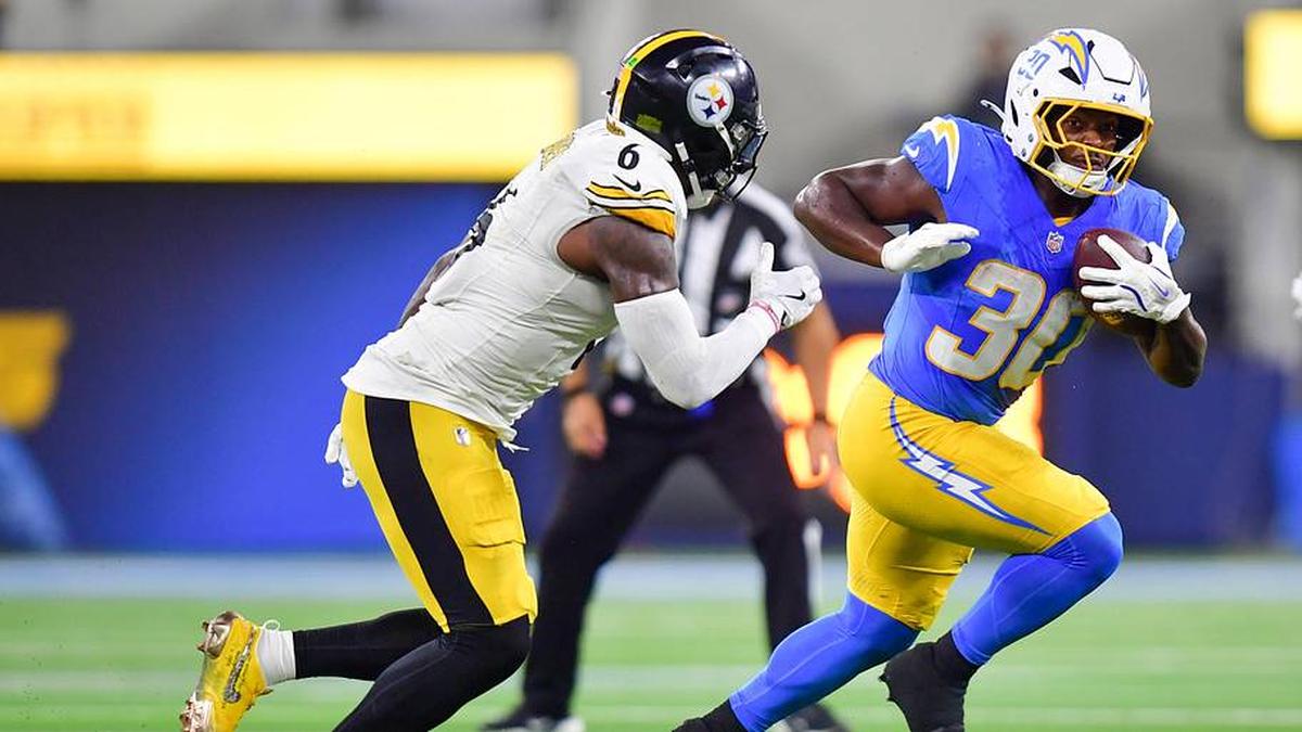  Nov 9, 2025; Inglewood, California, USA; Los Angeles Chargers running back Kimani Vidal (30) carries the ball defended by Pittsburgh Steelers linebacker Patrick Queen (6) during the second quarter of the game at SoFi Stadium. Mandatory Credit: Gary A. Vasquez-Imagn Images | Gary A. Vasquez-Imagn Images 