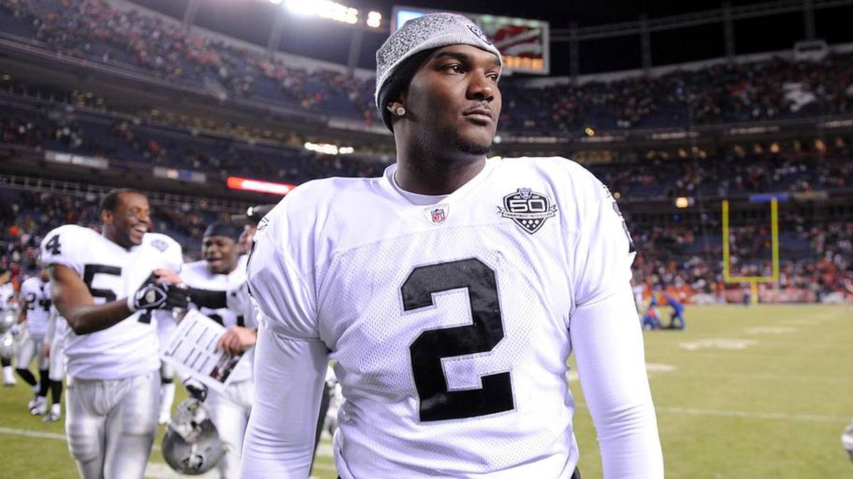  Dec 20, 2009; Denver, CO, USA; Oakland Raiders quarterback JaMarcus Russell (2) walks off the field after the Raiders' 20-19 victory over the Denver Broncos at Invesco Field. Mandatory Credit: Kirby Lee/Image of Sport-Imagn Images | Kirby Lee-Imagn Images 
