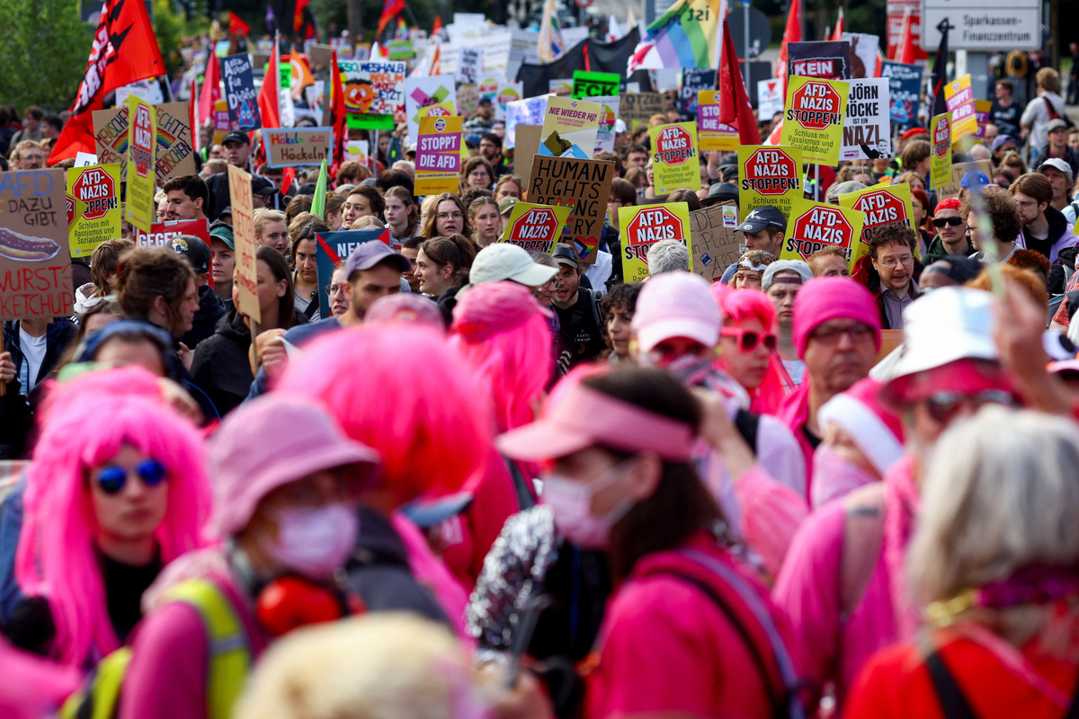 People carry flags and placards during protests against a two-day party convention of Germany's far-right Alternative for Germany (AfD) party, in Erfurt, Germany, July 4, 2026. REUTERS/Thilo Schmuelgen