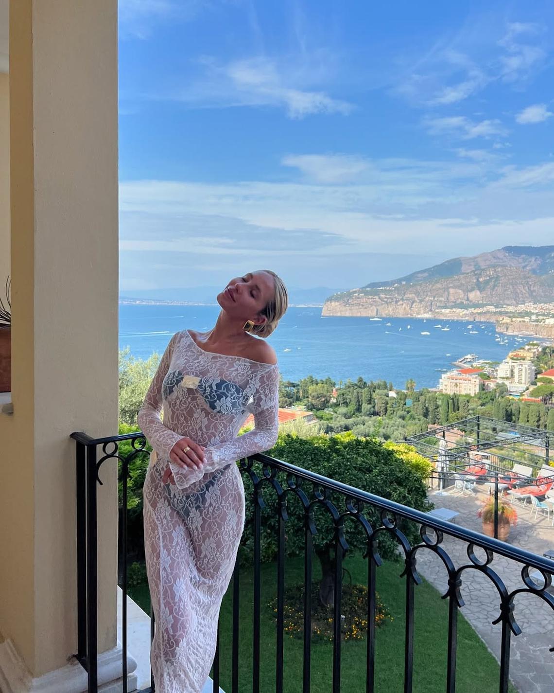 Serotonin in Sorrento Alix looked unbothered and glowing during an August 2024 trip to Italy. The University of Miami alumna paired a beautiful strapless black bikini with a long-sleeved lace dress. The gold embellishments of the swimsuit peeked out underneath the gown, which she paired with matching chunky earrings. Alix Earle/ Instagram