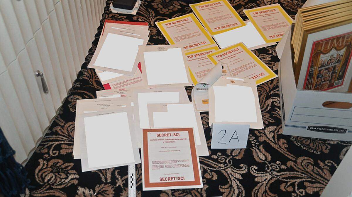 This August 2022 image contained in a court filing by the Department of Justice shows a redacted FBI photograph of certain documents and classified cover sheets recovered from a container in the “45 office” seized during the Aug. 8, 2022, search of former President Donald Trump’s Mar-a-Lago estate in Florida.