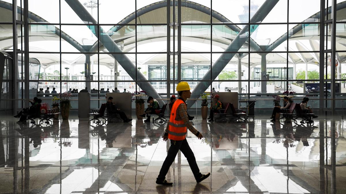 A worker walks at the Terminal 2 of Guangzhou Baiyun International Airport in Guangdong province, China April 20, 2018.  China Daily via REUTERS