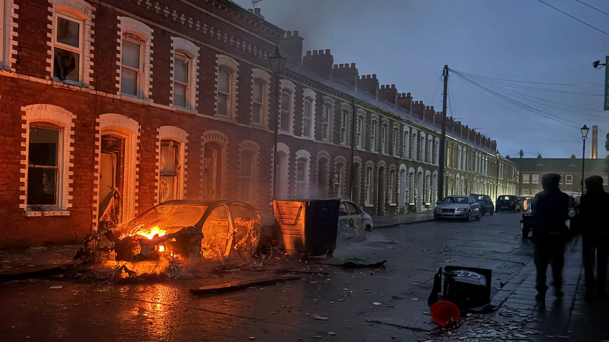 A car burns in east Belfast, during a protest after a knife attack on June 8 left a man seriously injured and prompted police to declare a critical incident, in Belfast, Northern Ireland, June 9, 2026. Picture taken wih a phone. REUTERS/Isabel Infantes