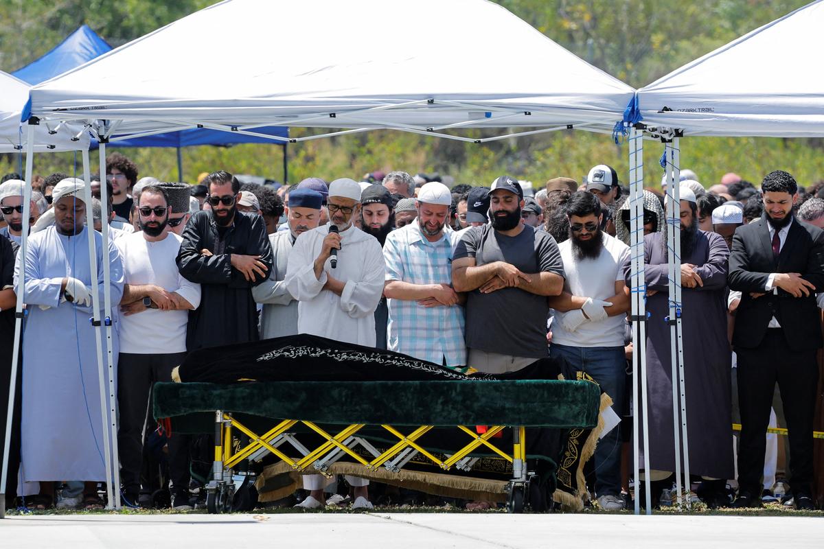 People attend a prayer service for the victims of a shooting at the Islamic Center, in San Diego, California, U.S. May 21, 2026.  REUTERS/Mike Blake