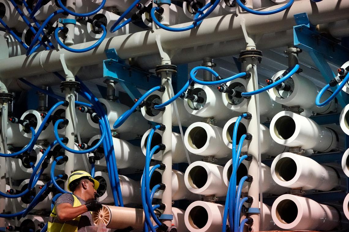 A man performs maintenance work in the reverse osmosis building at the Carlsbad Desalination plant in May in Carlsbad. The facility is the Western hemisphere’s largest desalination plant, which removes salt and impurities from ocean water.