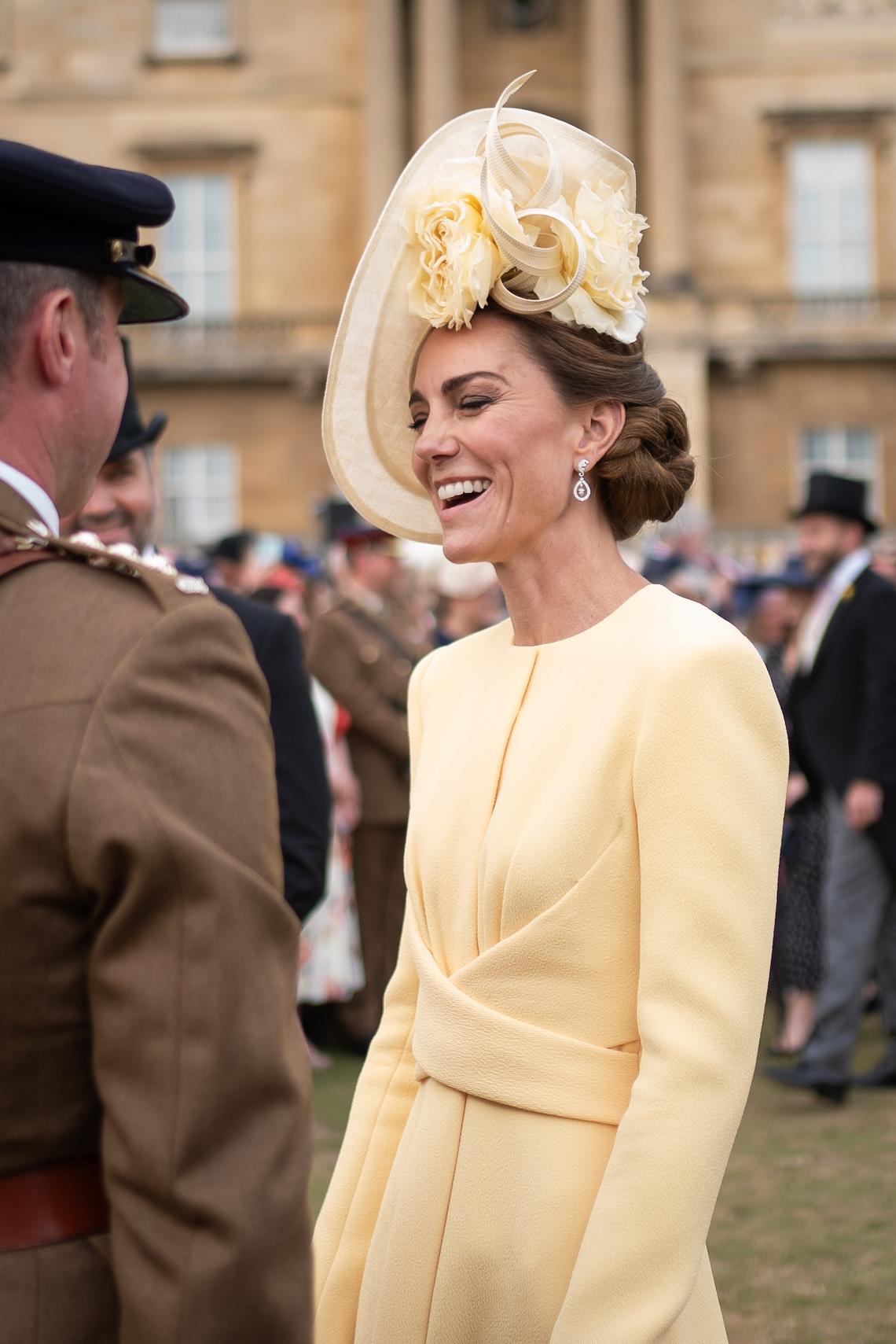 Same Hat, Different Style Unlike her loose, flowy hairstyle at Meghen and Harry's wedding, Kate wrapped her hair in a low side bun at the Royal Garden Party in May 2025. Kate paired the accessory with a matching long-sleeved dress that fell down to her knees. Photo by Aaron Chown - WPA Pool / Getty Images