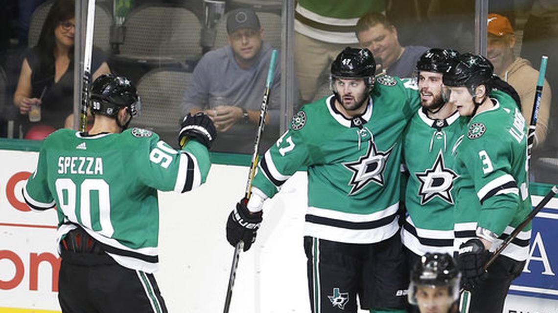 Dallas Stars forward Tyler Seguin, second from right, is congratulated by teammates after scoring a goal during the first period of an NHL hockey game against the Winnipeg Jets, Saturday, Oct. 6, 2018, in Dallas.
