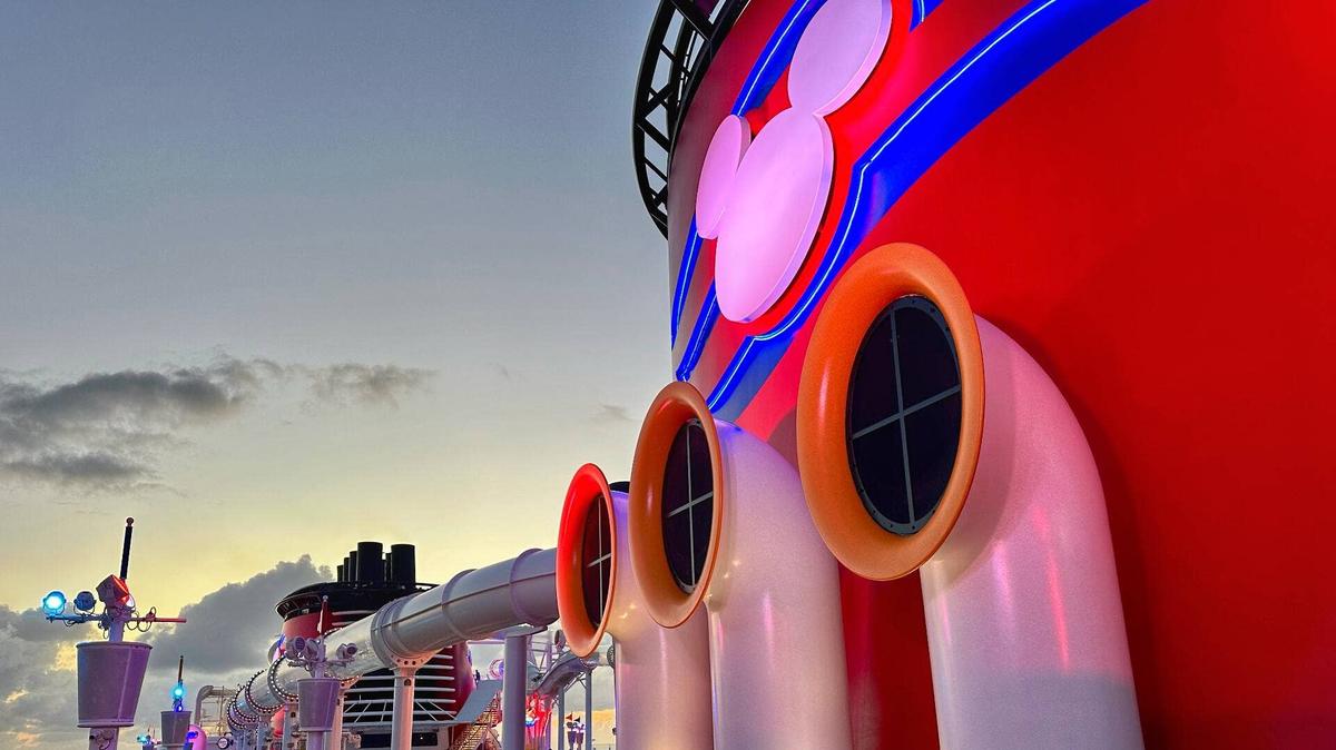 Disney Fantasy cruise ship funnel at sunset lead. 
