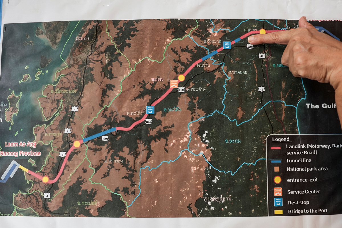 Chalermusa Seekhiao, 56, points at a map showing the route of Thailand's proposed Southern Land Bridge project, a route linking Ranong and Chumphon provinces, as part of Thailand’s proposed Southern Land Bridge project to connect the Andaman Sea and the Gulf of Thailand, in Phato district, Chumphon province, Thailand, May 18, 2026. REUTERS/Chalinee Thirasupa