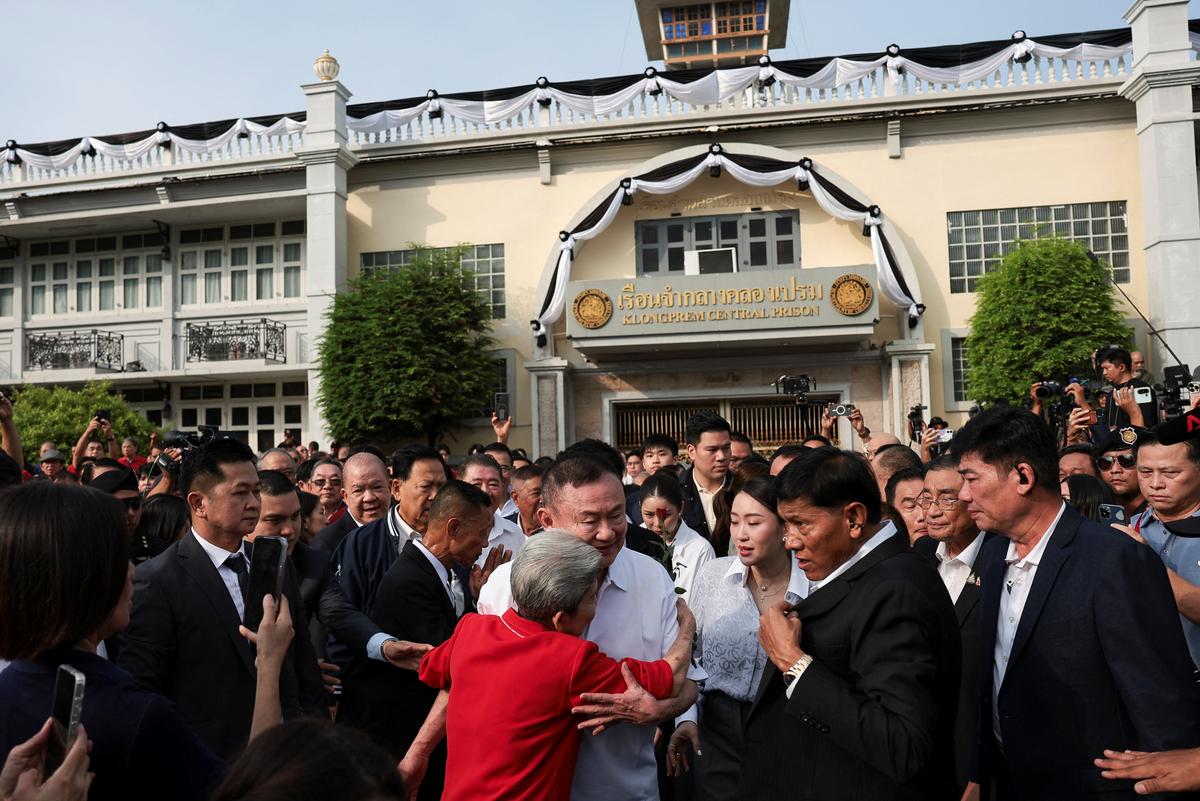 Former Thai Prime Minister Thaksin Shinawatra hugs a supporter following his release on parole after serving eight months of his one-year sentence at Klong Prem Central Prison, in Bangkok, Thailand, May 11, 2026. REUTERS/Chalinee Thirasupa
