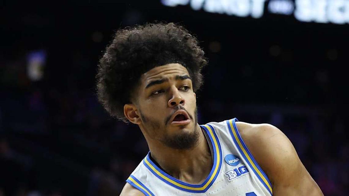  Mar 20, 2026; Philadelphia, PA, USA; UCLA Bruins guard Eric Freeny (8) makes a pass against UCF Knights center John Bol (7) in the second half during a first round game of the men's 2026 NCAA Tournament at Xfinity Mobile Arena. Mandatory Credit: Bill Streicher-Imagn Images | Bill Streicher-Imagn Images 