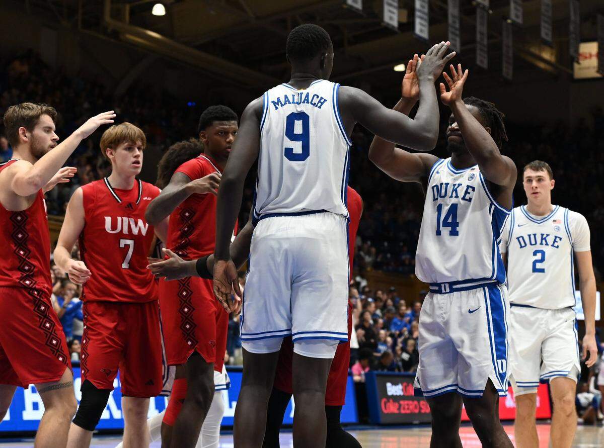 Duke Blue Devils center Khaman Maluach (9) is greeted by teammate Sion James (14) after scoring during the second half against the Incarnate Word Cardinals at Cameron Indoor Stadium.