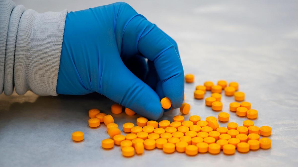 A Drug Enforcement Administration (DEA) chemist checks confiscated pills containing fentanyl at the DEA Northeast Regional Laboratory on Oct. 8, 2019 in New York. (Don Emmert/AFP/Getty Images/TNS)