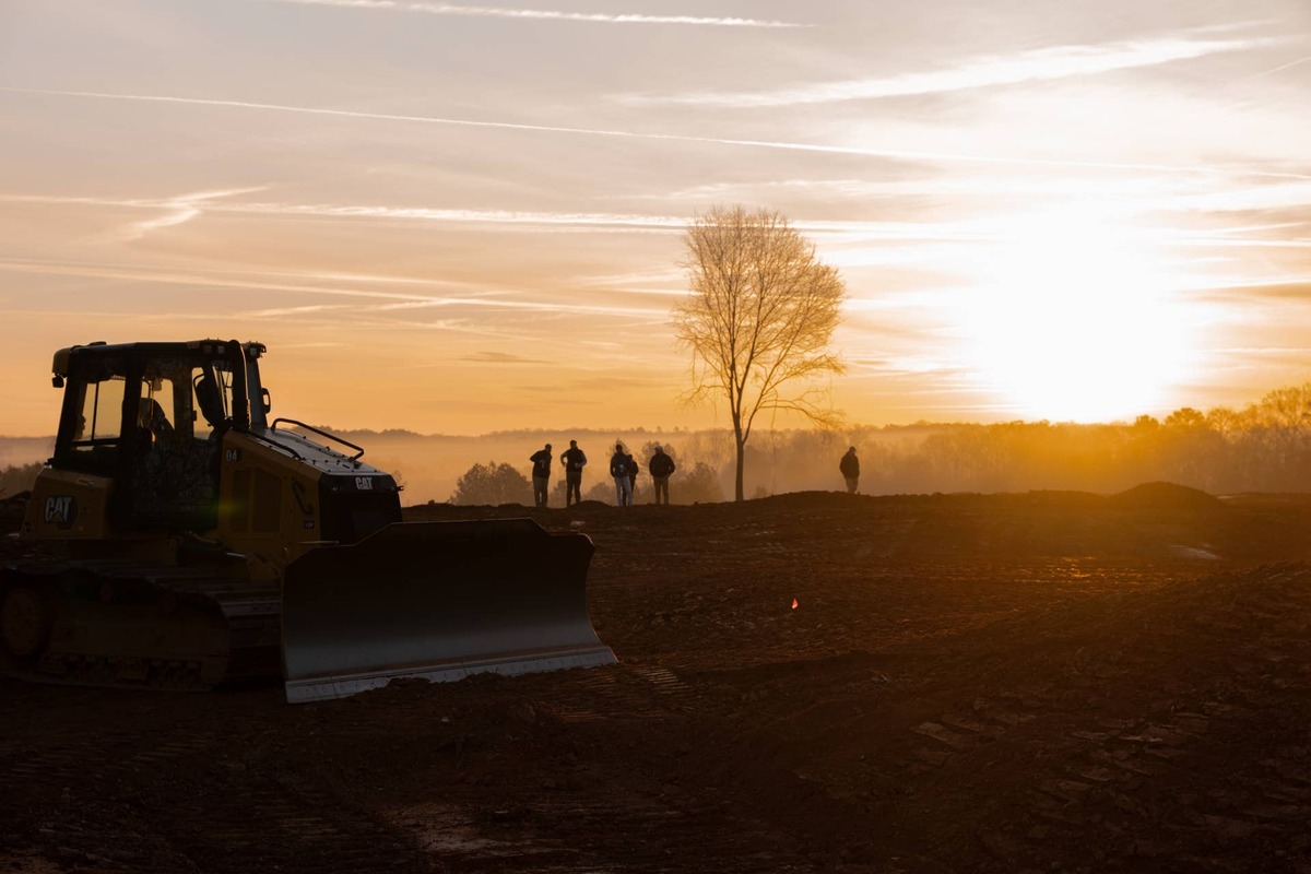  Construction crews begin another day at Kawonu Golf Club as the sun rises over the future private golf destination near Greenville, South Carolina. The project continues making steady progress toward its planned spring 2027 opening. Courtesy of Kawonu Golf Club.