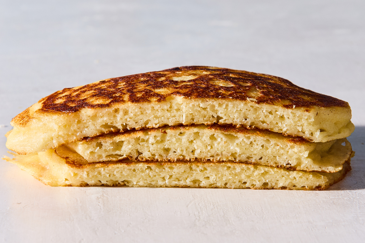 Buttermilk pancakes after no rest for the batter. If you haven't let the batter rest, those first few pancakes will turn out too thin, with the batter running all over the pan. Food Stylist: Monica Pierini. (Julia Gartland/The New York Times)