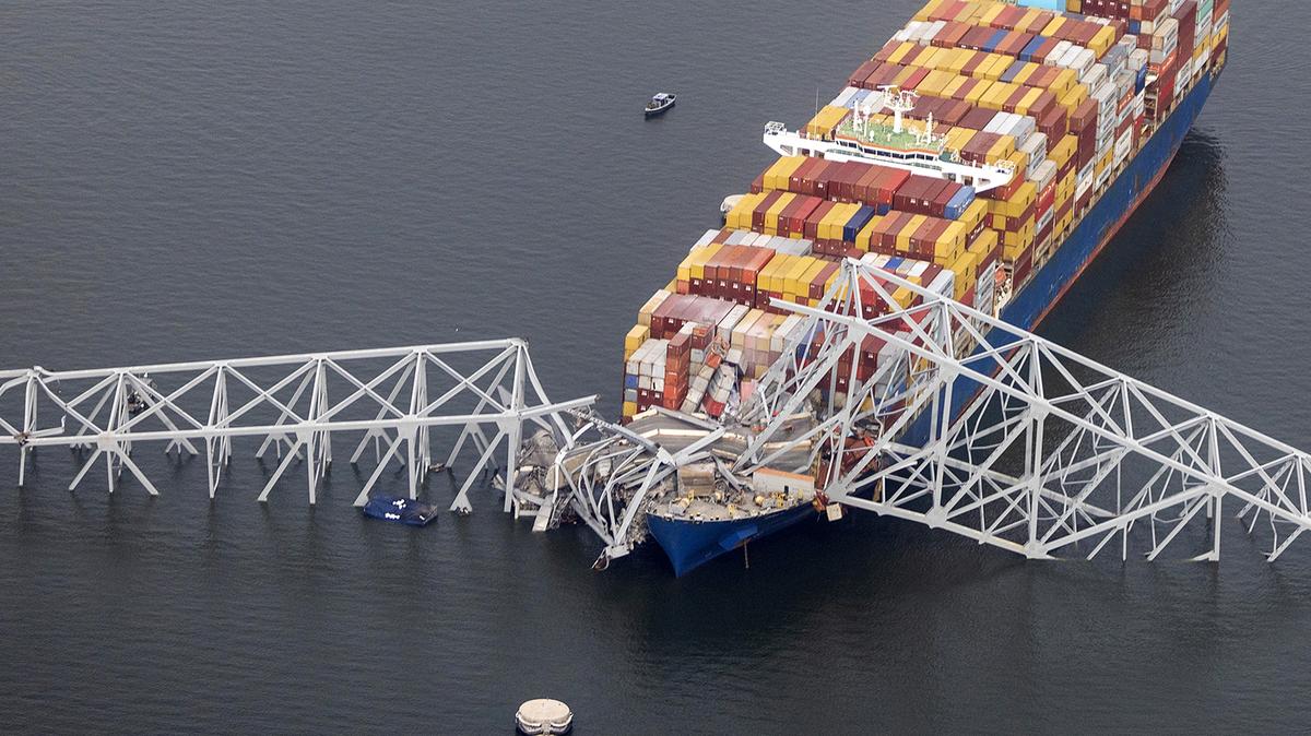 In an aerial view, the cargo ship Dali sits in the water after running into and collapsing the Francis Scott Key Bridge on March 26, 2024, in Baltimore, Maryland. According to reports, rescuers are still searching for multiple people, while two survivors have been pulled from the Patapsco River. A work crew was fixing potholes on the bridge, which is used by roughly 30,000 people each day, when the ship struck at around 1:30am on Tuesday morning. The accident has temporarily closed the Port of Baltimore, one of the largest and busiest on the East Coast of the U.S. (Tasos Katopodis/Getty Images/TNS)
