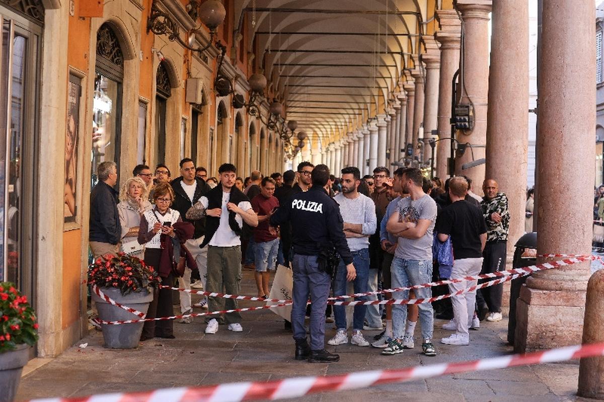 People gather behind police tape near the scene after several people were injured when a car drove into pedestrians in the center of the northern Italian city of Modena, Italy, May 16, 2026. REUTERS/Stringer