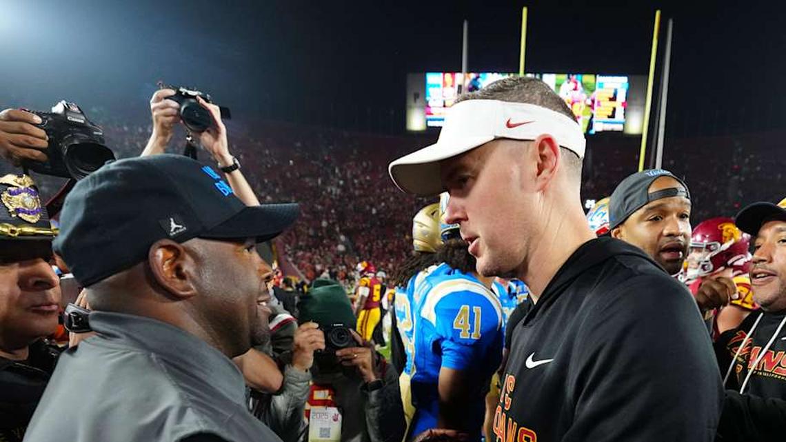  Nov 29, 2025; Los Angeles, California, USA; UCLA Bruins interim coach Tim Skipper (left) shakes hands with Southern California Trojans head coach Lincoln Riley after the game at United Airlines Field at Los Angeles Memorial Coliseum. Mandatory Credit: Kirby Lee-Imagn Images | Kirby Lee-Imagn Images 