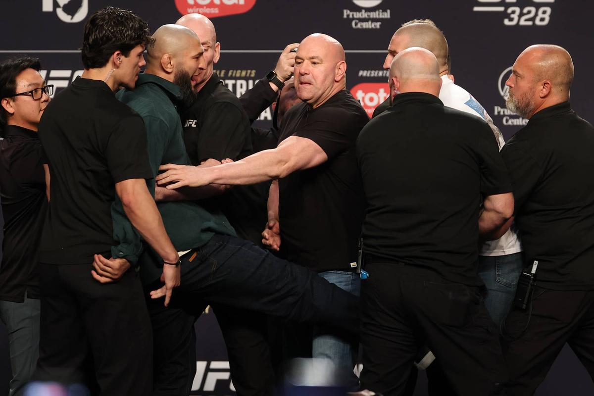  (L-R) Khamzat Chimaev kicks Sean Strickland during a face off on stage at the UFC 328 press conference in Newark, New Jersey. Ed Mulholland/Zuffa LLC-GettyImages
