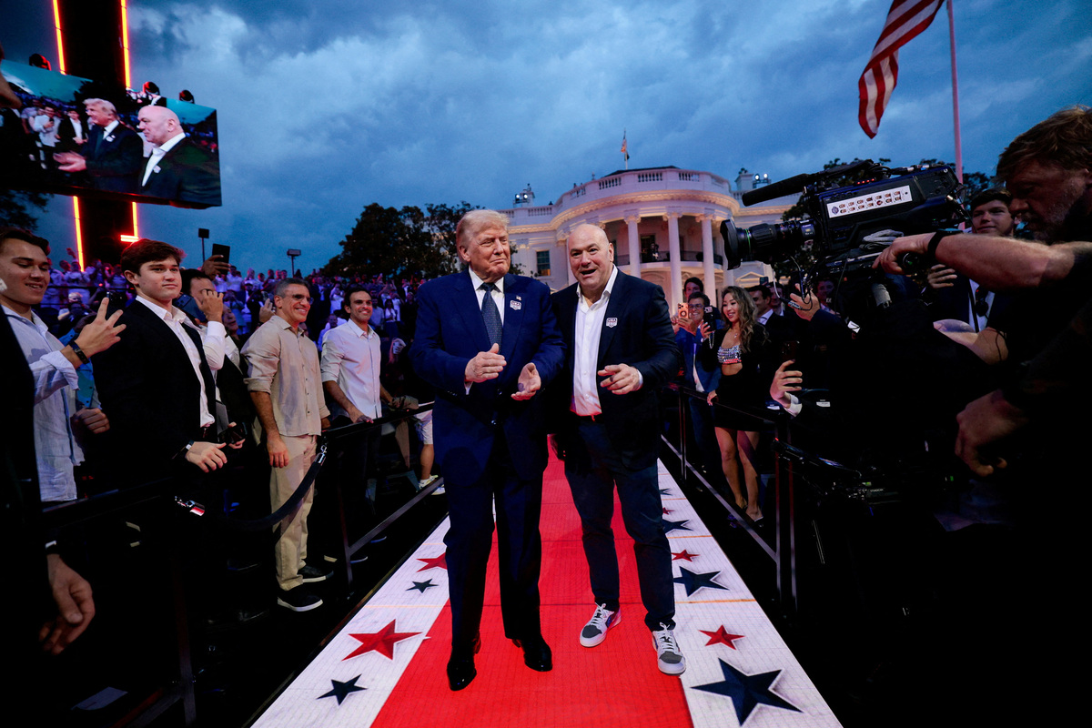 U.S. President Donald Trump arrives with UFC CEO Dana White for UFC Freedom 250 on the South Lawn of the White House in Washington, D.C., U.S., June 14, 2026. REUTERS/ Evan Vucci