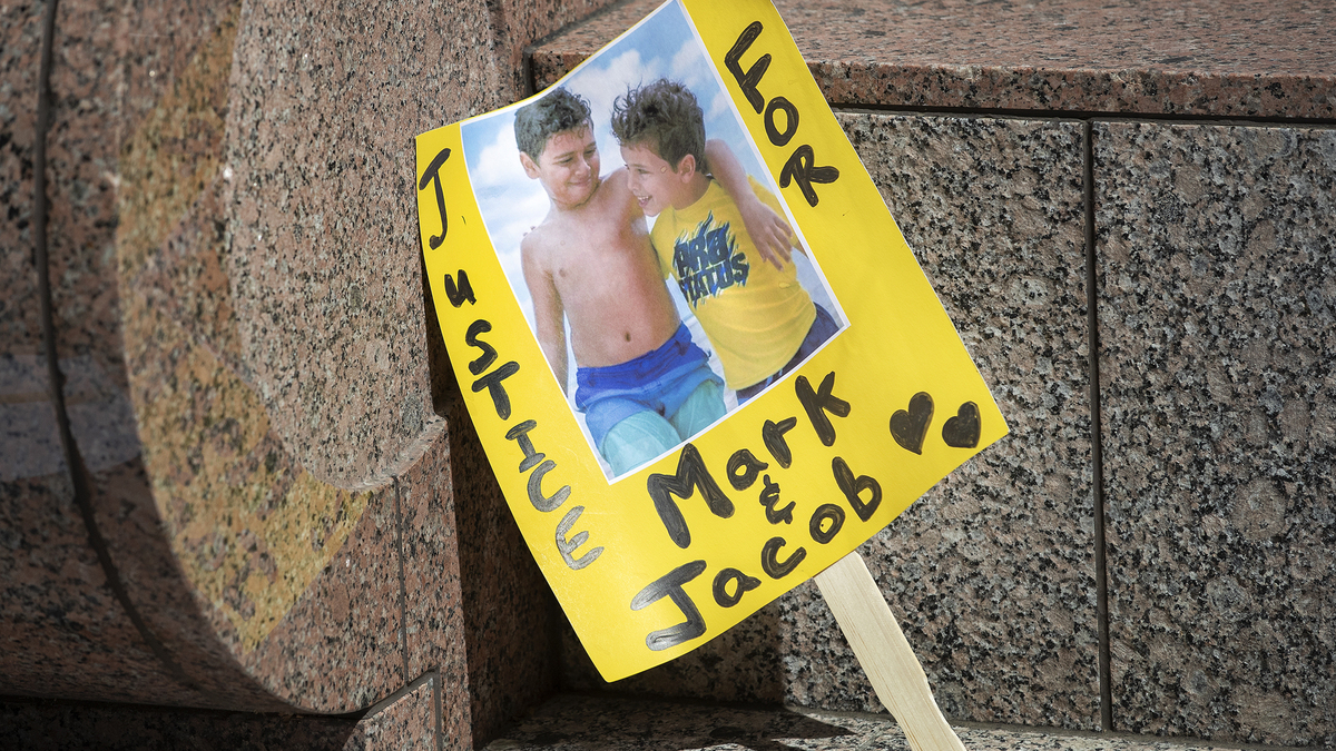 A sign outside the Van Nuys Courthouse in 2022 shows an image of Mark Iskander, 11, and his brother Jacob, 8. They were fatally struck by an SUV driven by Rebecca Grossman in 2020. (Mel Melcon/Los Angeles Times/TNS)