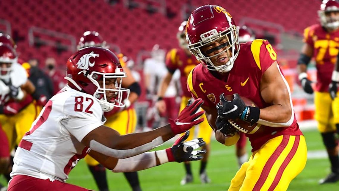  Dec 6, 2020; Los Angeles, California, USA; USC Trojans wide receiver Amon-Ra St. Brown (8) hangs on to the ball as he battles Washington State Cougars linebacker Travion Brown (82) into the end zone for a touch down in the first quarter of the game at United Airlines Field at the Los Angeles Memorial Coliseum. Mandatory Credit: Jayne Kamin-Oncea-Imagn Images | Jayne Kamin-Oncea-Imagn Images 