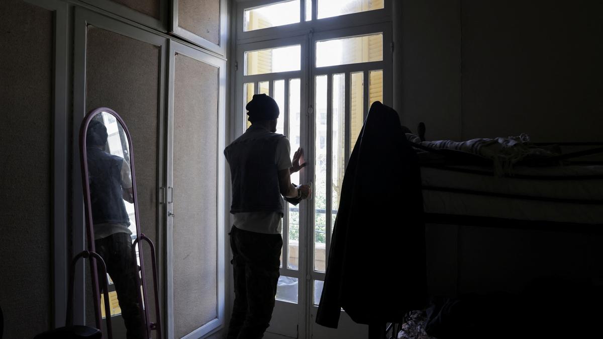 Mohammed, a gay man displaced from southern Lebanon, who spoke to Reuters on condition that his last name not be used, closes the door at a temporary shelter for displaced people in Beirut, Lebanon, May 4, 2026. REUTERS/Raghed Waked.