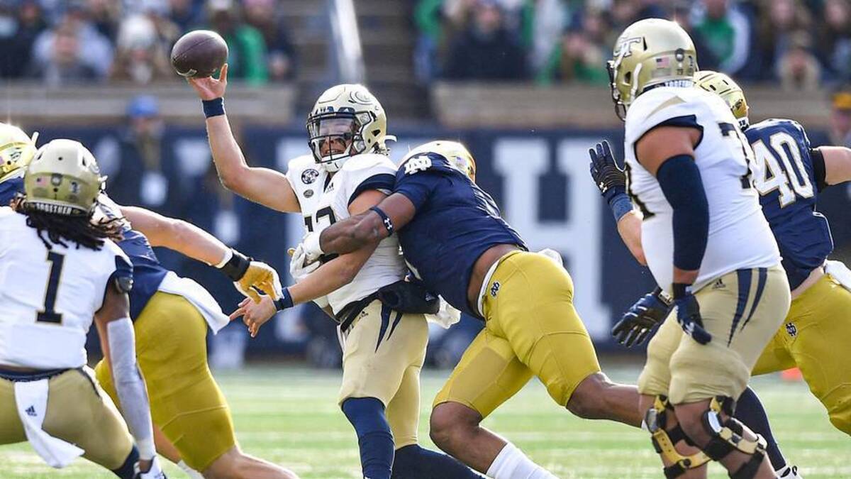  Nov 20, 2021; South Bend, Indiana, USA; Georgia Tech Yellow Jackets quarterback Jordan Yates (13) is hit as he throws by Notre Dame Fighting Irish defensive lineman Isaiah Foskey (7) in the first quarter at Notre Dame Stadium. | Matt Cashore-Imagn Images 