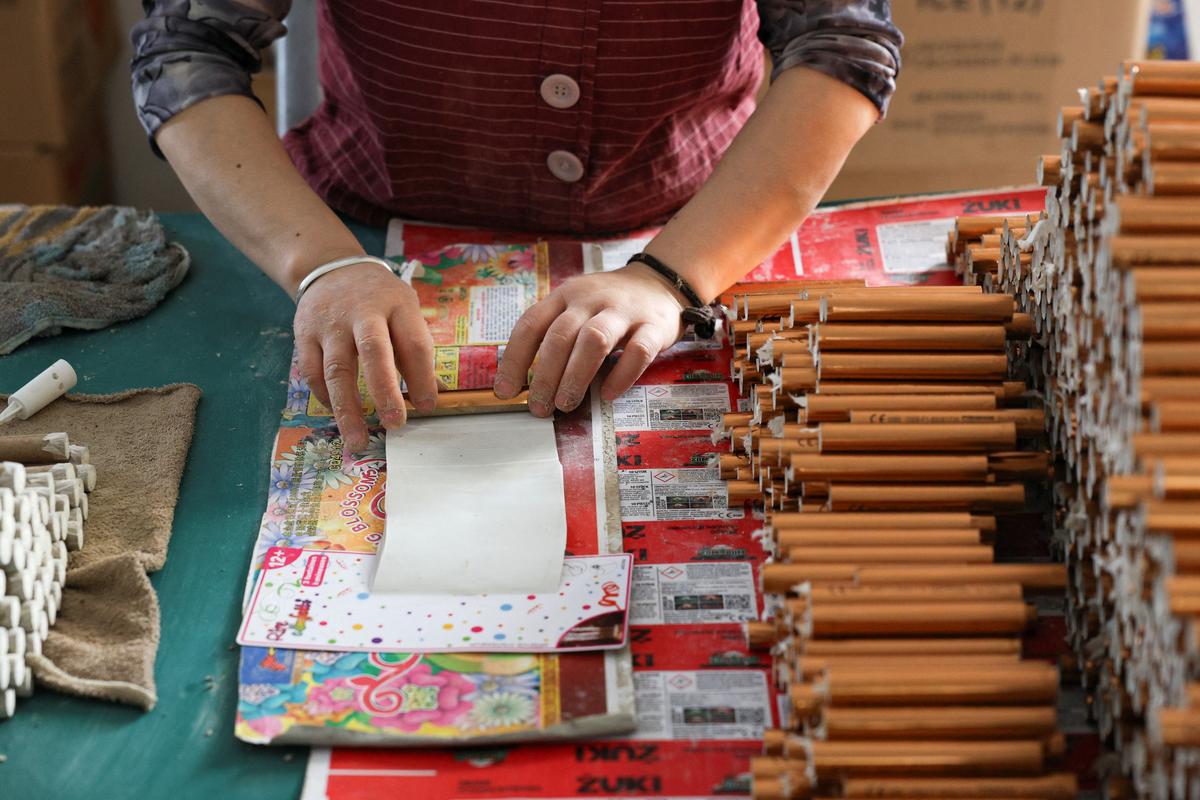 An employee works to assemble firework products at Chili Fireworks factory in Liling, Hunan province, China, April 10, 2026.  REUTERS/Go Nakamura