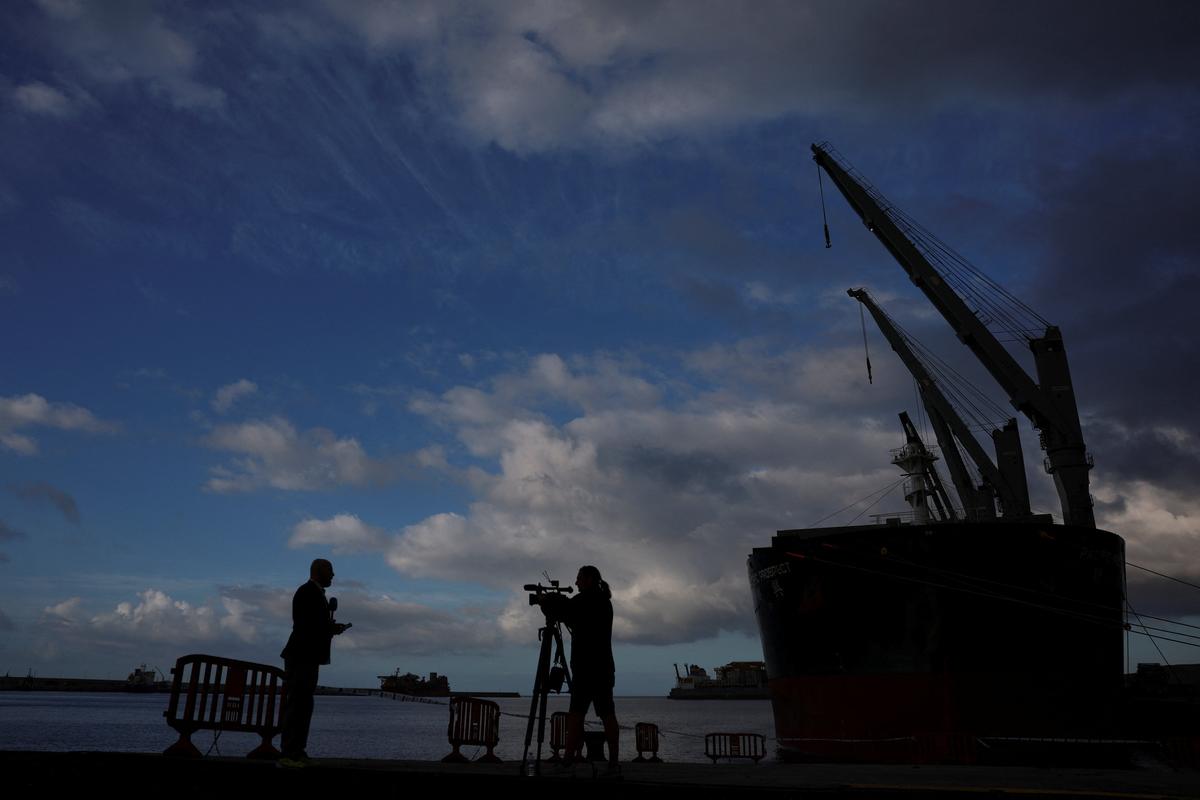 Members of the media work at the port of Granadilla de Abona, Tenerife, Canary Islands, Spain, where the cruise ship MV Hondius hit by a deadly hantavirus outbreak, is expected to arrive, May 9, 2026. REUTERS/Hannah McKay