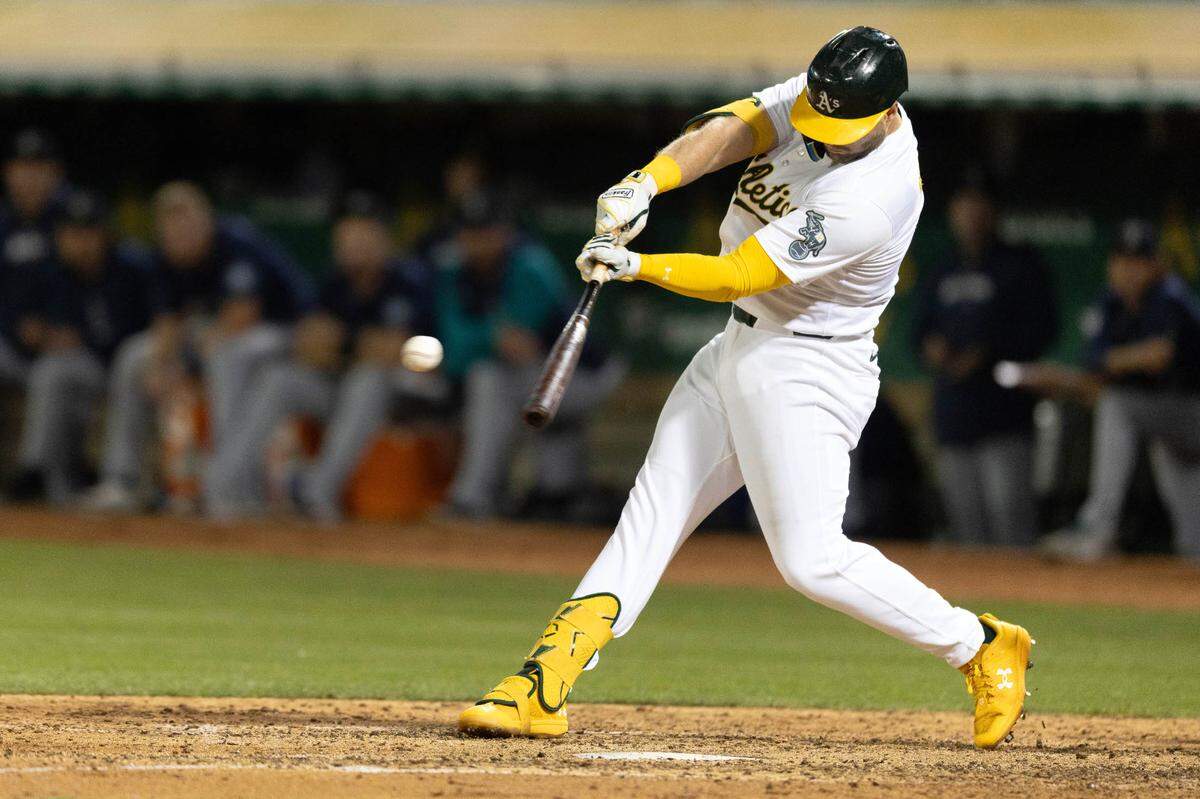 Oakland Athletics left fielder Seth Brown (15) hits a game-winning single against the Seattle Mariners during the ninth inning Sept. 3, 2024, at Oakland-Alameda County Coliseum.