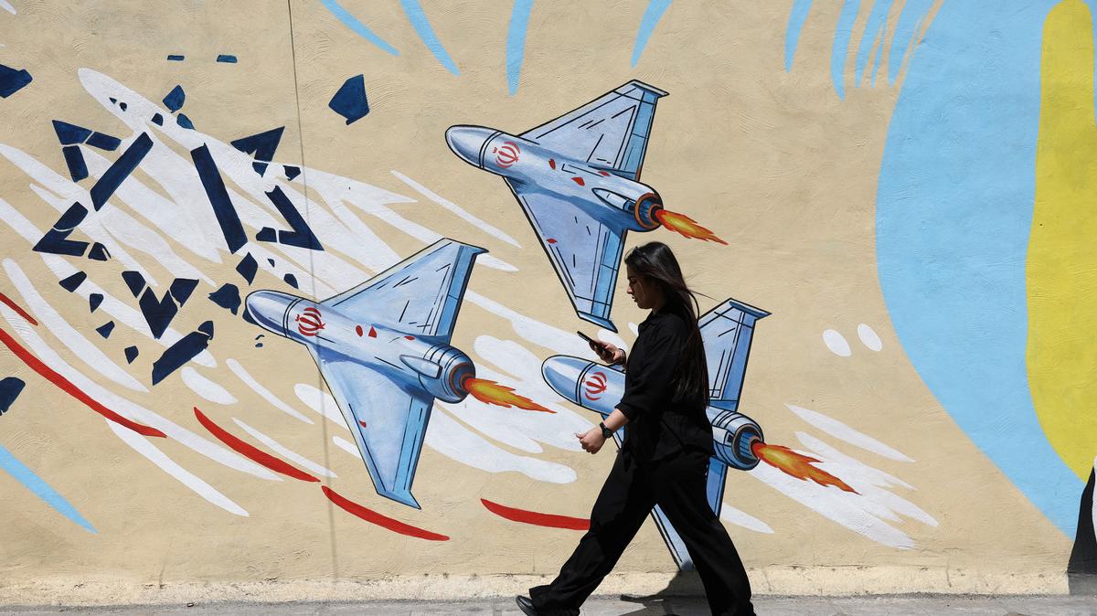 An Iranian woman walks next to an anti-Israeli mural on a street in Tehran, Iran, May 11, 2026. Tehran’s response to a U.S. proposal to end the war on Monday made clear the two sides were still far apart on a number of issues.