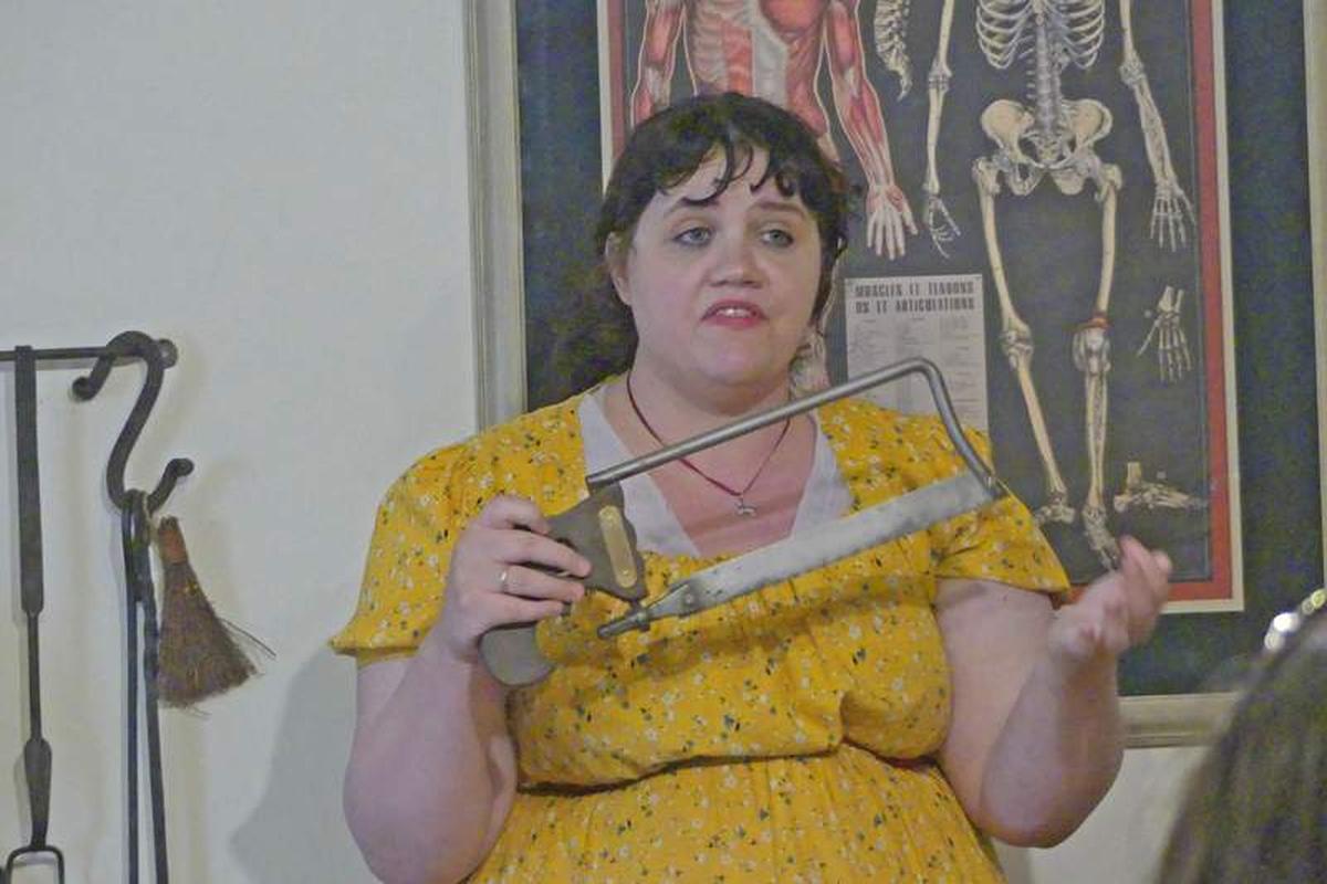  Our guide demonstrates a saw used for amputation in 18th-century St. Augustine. Photo credit: Kathleen Walls 