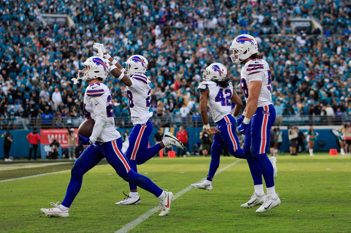  Buffalo Bills safety Cole Bishop (24), from left, celebrates his interception, sealing the game, with safety Sam Franklin Jr. (28), linebacker Dorian Williams (42) and linebacker Matt Milano (58), during the fourth quarter of an NFL football AFC Wild Card playoff matchup, Sunday, Jan. 11, 2026, in Jacksonville, Fla. The Bills defeated the Jaguars 27-24. [Corey Perrine/Florida Times-Union] 