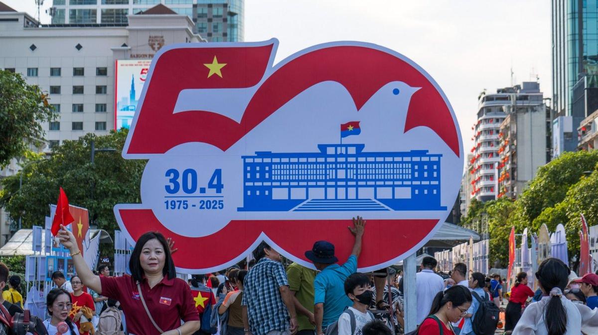 People pose in front of a sign commemorating the 50th anniversary of the end of the Vietnam War in Ho Chi Minh City, Vietnam, on April 26, 2025. The war ended on April 30, 1975, when North Vietnamese tanks and troops stormed the presidential palace. Photo by Thomas Maresca/UPI